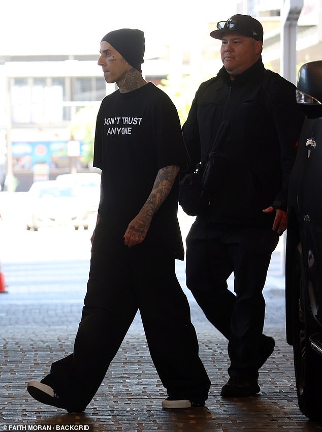 The actor showed off his numerous tattoos and completed his all-black look with a dark beanie to hide his head as he was swarmed by his entourage.