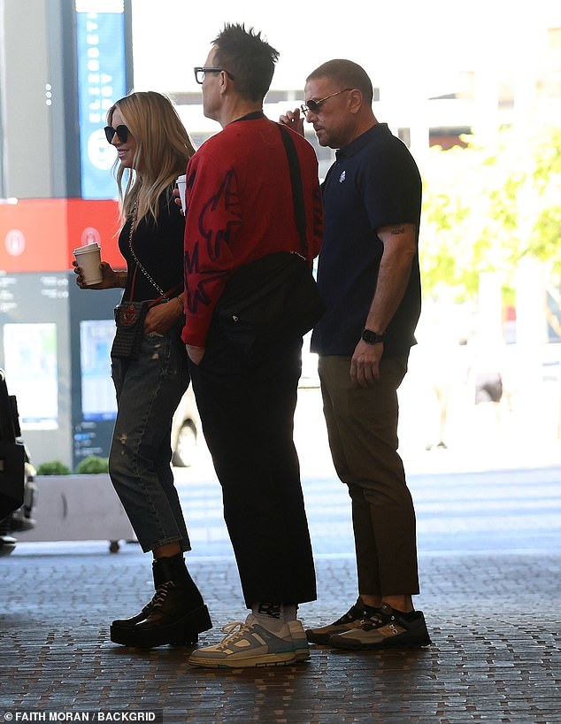 The last to get into his car was Mark, who opted for a trendy outfit with a red and black sweater over black ankle-length pants.