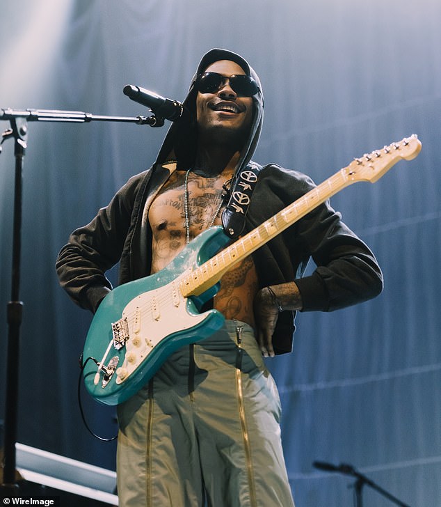 The American singer-songwriter, 25, hid his eyes behind sunglasses and also performed with a guitar while standing in the center of the stage