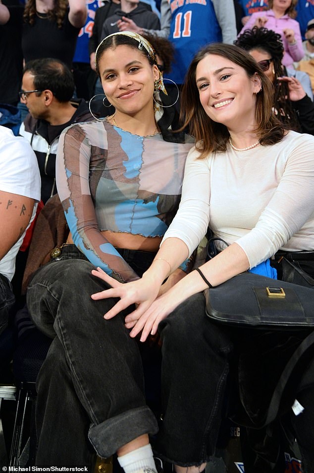 Zazie Beetz (left) looked in good spirits as she had a big smile on her face while wearing a semi-sheer patterned top and gray jeans as she sat next to a close friend