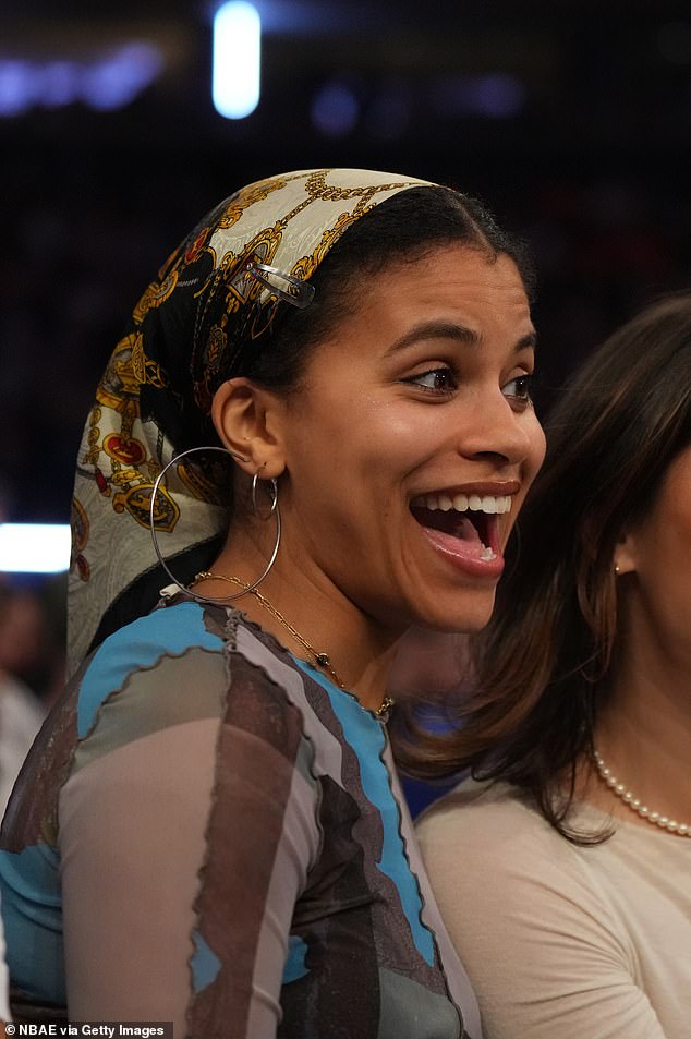 She completed her pre-game look by adding large silver hoop earrings as well as a dainty gold chain necklace.  As a finishing touch, a bandana was placed on her head