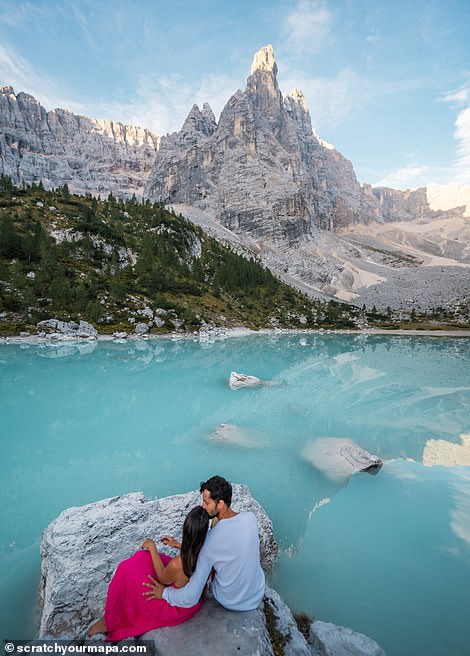 This photo captures the clear blue waters of Lago di Braies, a beautiful lake in the heart of the Dolomites