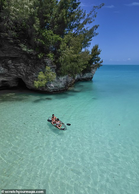 The couple is shown here in a transparent canoe, enjoying the azure waters of Spanish Point, Bermuda