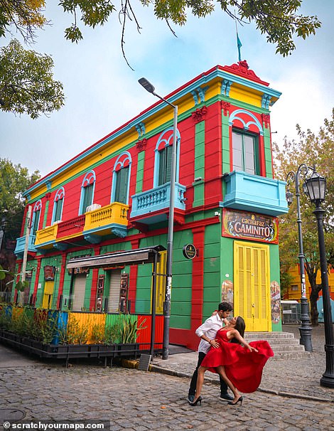 The couple poses in front of a colorful wall in Caminito, an open-air museum and traditional alley in La Boca, a neighborhood in Buenos Aires