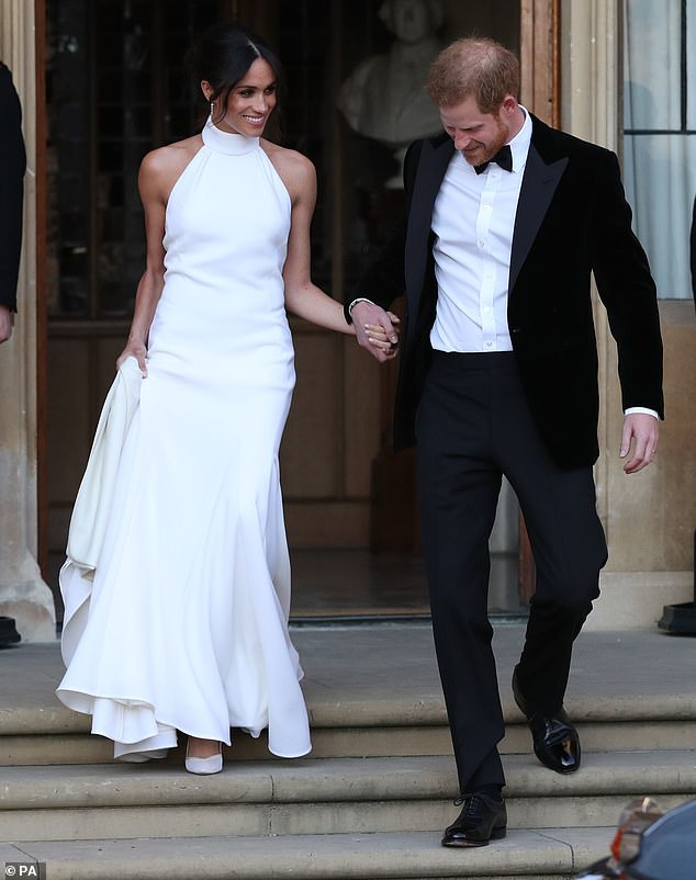 Paired with a high-neck Stella McCartney dress made from silk crepe, Meghan wore a pair of silky satin Aquazurra shoes with soles painted in baby blue on the day of her wedding reception