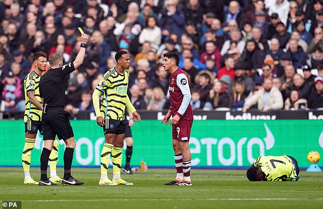 West Ham United's Edson Alvarez (centre) was shown a yellow card by referee Craig Pawson for a foul on Arsenal's Bukayo Saka (right)