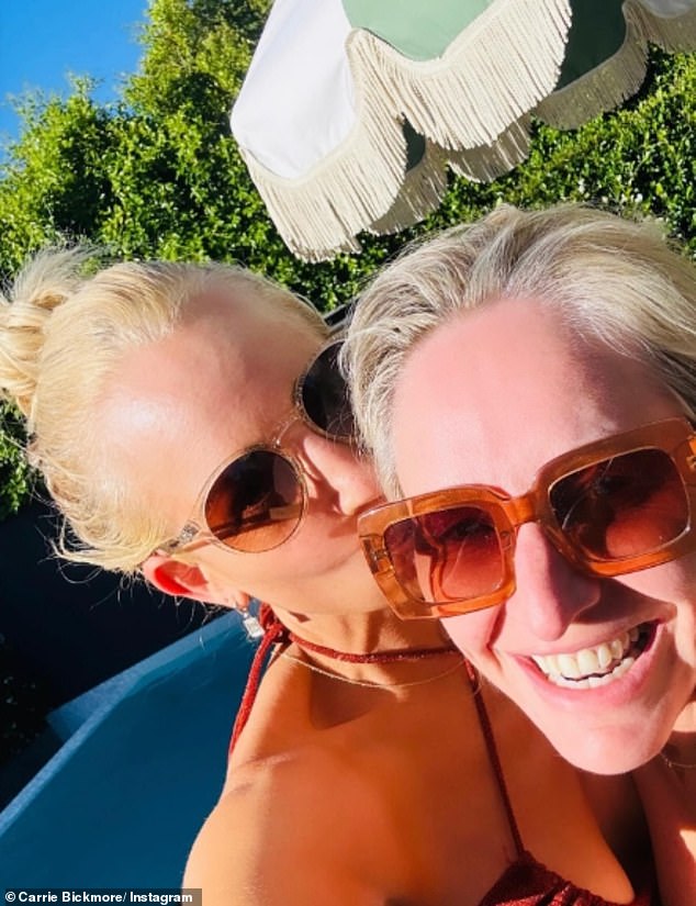 The ageless beauty showed off her best angles in a black thong bikini as she posed with friends including her radio star bestie Fifi Box (pictured right)