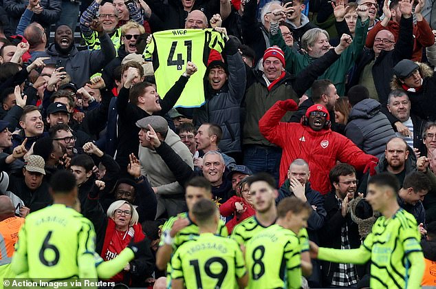 Arsenal fans celebrate after Rice's goal and hold the England international's shirt in the stands