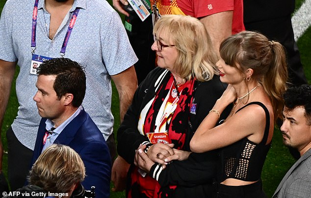 Girlfriend Taylor Swift watched from nearby and held the hand of Travis' mother Donna