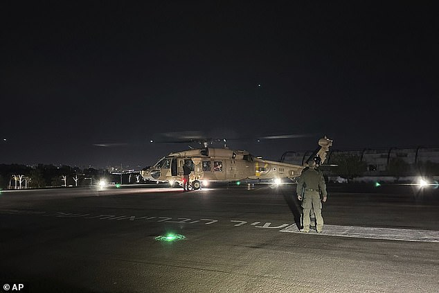 This photo provided by the Israeli military shows an Israeli Air Force helicopter carrying the two hostages