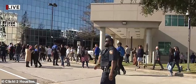 A woman in a trench coat entered famed pastor Joel Osteen's megachurch in Houston and began shooting and was killed Sunday afternoon by two off-duty officers working security, police said