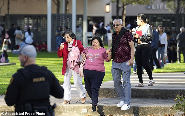 Houston police officers watch over displaced churchgoers outside Lakewood Church,