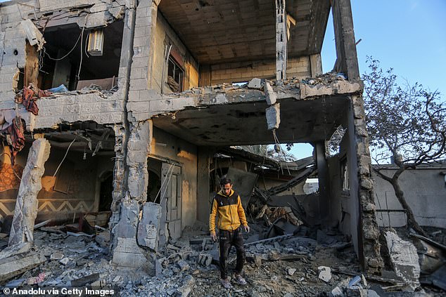 Palestinians inspect damaged apartment buildings after Israeli attacks in Rafah, Gaza on February 11