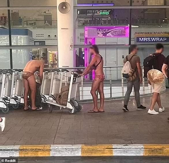 The image, taken at Phuket airport, showed the two men loading trolleys with bags