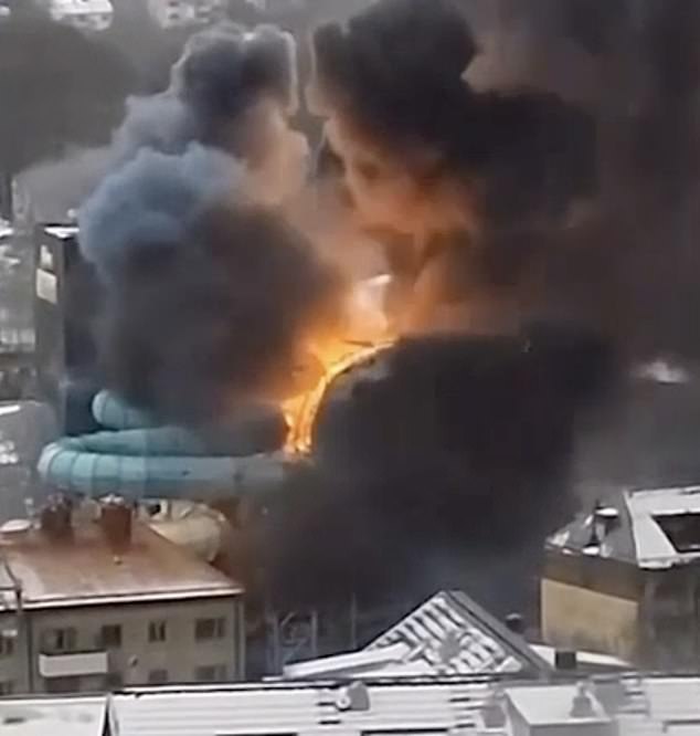 An explosion can be seen behind snow-covered houses near the water park's slide
