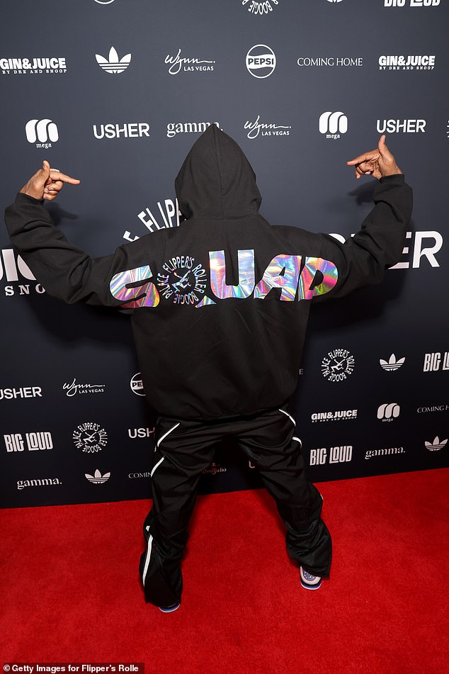 The hitmaker wore a black hoodie with 'squad' written in colorful letters on his back as he posed on the red carpet