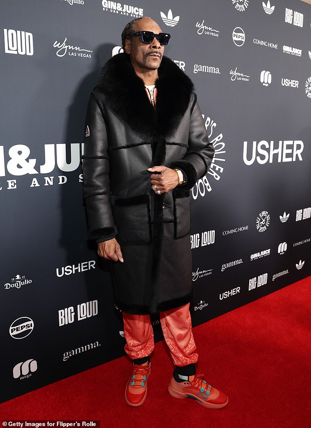 The rapper added a long black fur coat to the look and stayed comfortable in a pair of matching red sneakers