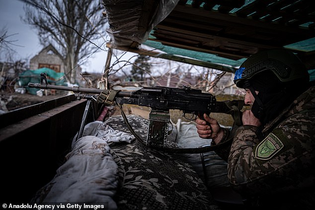 Ukrainian soldier of the Ukrainian Volunteer Army stands in a fortified position, in a secret location next to the Vuhledar front line