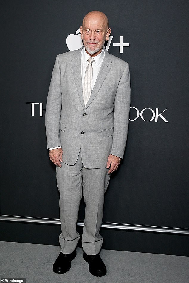 John Malkovich, who plays Lucien Lelong, wore a light gray suit at the premiere