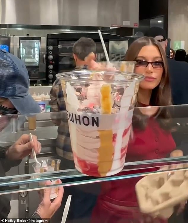 She wasn't afraid to get her hands dirty as she made the sweet treat herself and poured sauces and toppings over the ice cream.