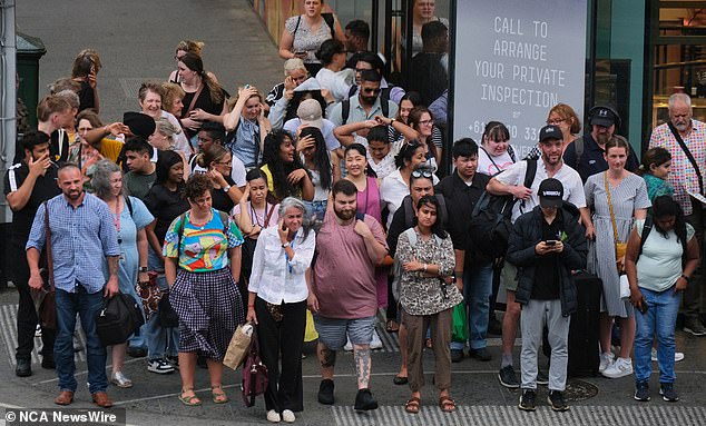 Commuters in Melbourne took cover from the rain on Tuesday afternoon