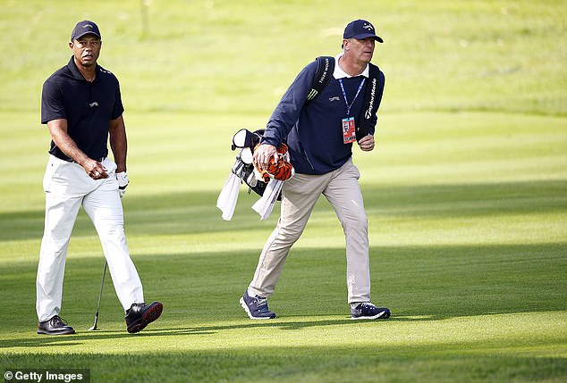 Woods, seen with his caddy Lance Bennett, has not played a full-field event since the Masters