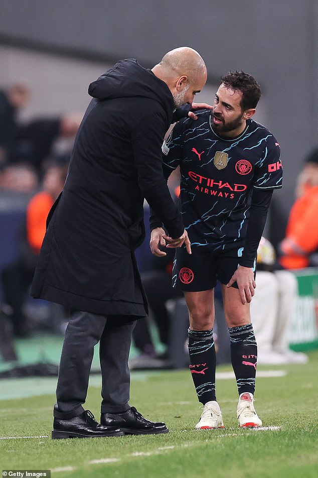 Guardiola speaks to Silva after he limped off with an ankle injury on Tuesday evening