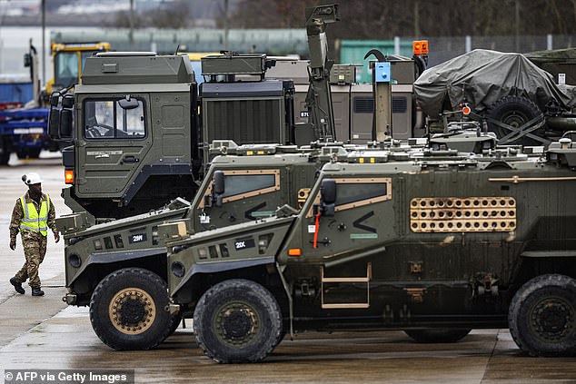 Foxhound armored vehicles belonging to the British Army's 7 Light Mechanized Brigade unit are loaded by members of the Royal Logistics Corps