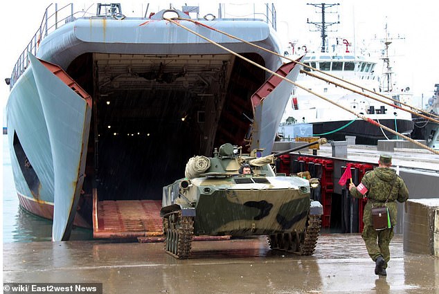 An armored vehicle disembarks from the Caesar Kunikov landing ship