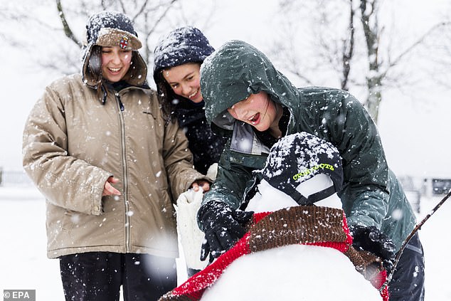 Brown University students put the finishing touches on a snowman Tuesday at India Point Park in Providence, Rhode Island