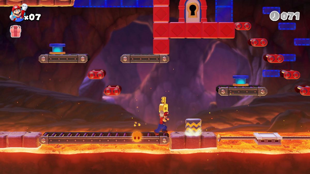 Mario carries a large key to a locked door in a lava level