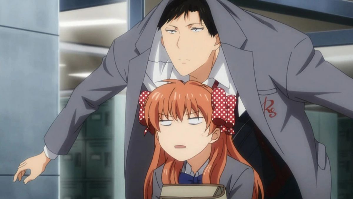 A tall young man with dark hair stretches his arms so that his jacket covers a little girl with orange hair to protect her from the rain.  But he is stacked over her and positioned so that his coat also covers his head.  He looks very serious, she looks vaguely irritated.