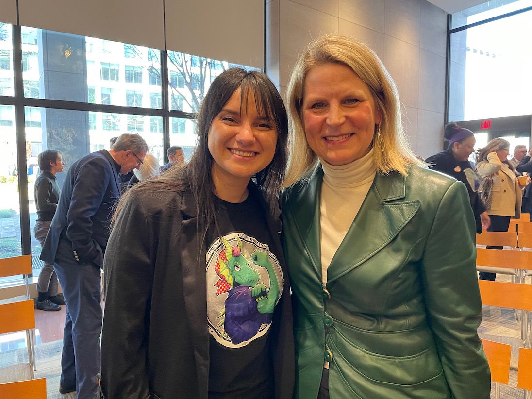 Autumn Mitchell, the author, poses with Liz Shuler, president of the AFL-CIO.  Autumn bears a CWA bud.