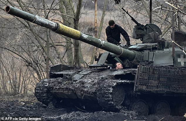 Ukrainian soldiers check their tank after maintenance not far from Bakhmut in the Donetsk region on February 5