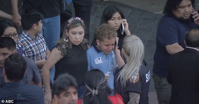 Immediately after she started shooting, two off-duty police officers working security at Lakewood Church shot her, killing her.  In the photo: a boy leaving the church crying on the phone during the shooting