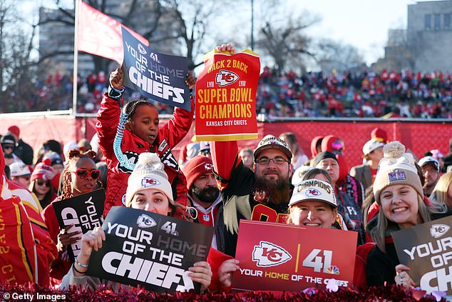 Fans gathered along the parade route Wednesday wearing commemorative hats and banners