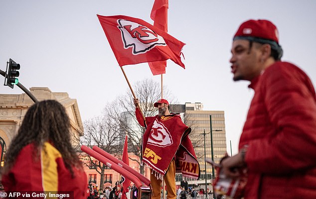 One supporter wears a team poncho while waving the Kansas City flag before the start