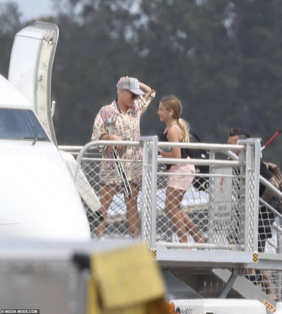 Pink appeared to be in better spirits as she boarded a plane after being denied entry to a club on Sydney Harbor earlier this week