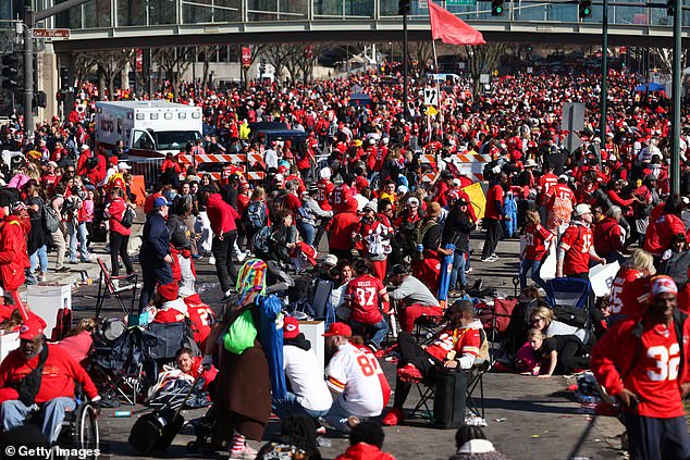 A frenzied crowd is seen falling to the ground after shots were fired during the festive parade in Kansas City, Missouri