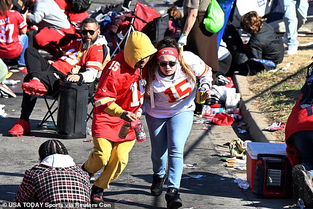 Two people dressed in Chiefs uniforms dive and run during the ordeal on Wednesday