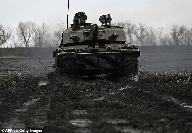 A Ukrainian soldier from the 82nd Separate Air Assault Brigade prepares for combat in a Challenger 2 tank at a secret location near the front line in the Zaporizhia region, on February 12, 2024