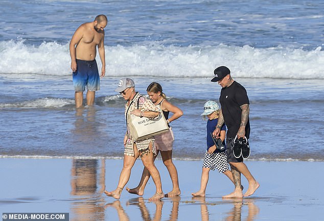 The family of four decided to explore the sights with a walk on the beach