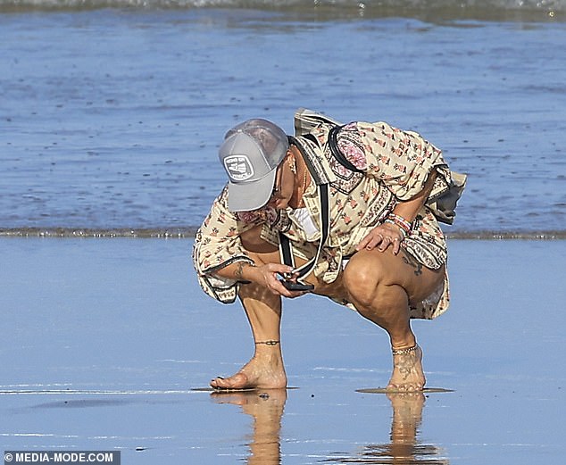 Crouching low on the sand, Pink inspected one of the bluebottles that washed up on the shoreline