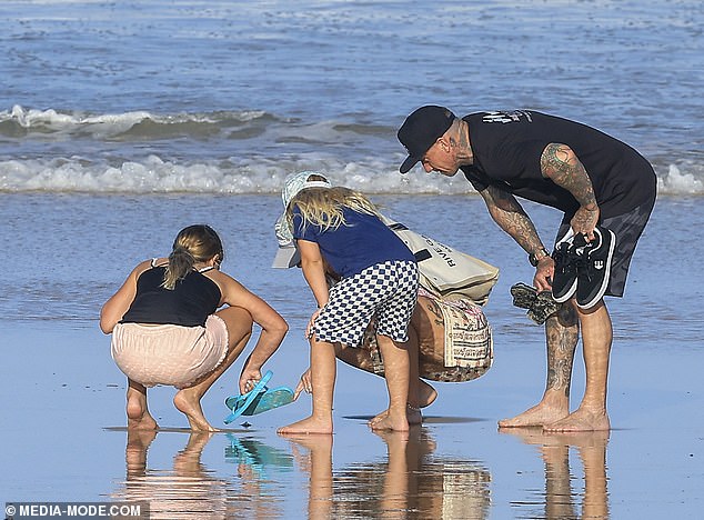 The brave mother and her family all crouched down to take a closer look at the common creature