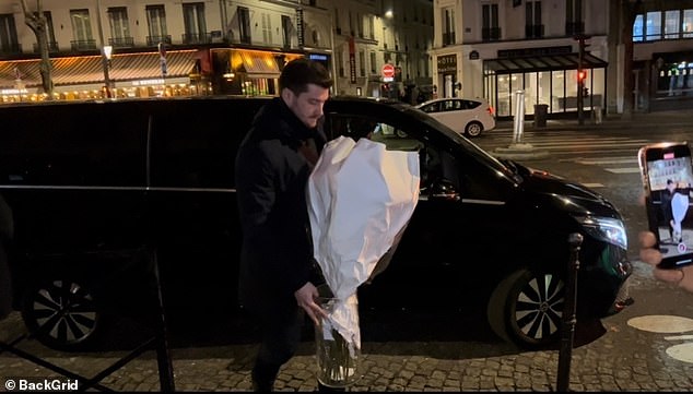 The couple's bodyguard was spotted with flowers delivered to Rihanna during their romantic night out in Paris