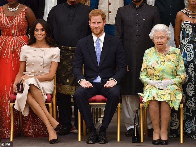 It is claimed that the new website with their Sussex titles was a betrayal of their agreement with the late Queen (Photo: The Duke and Duchess of Sussex with Queen Elizabeth II at Buckingham Palace in June 2018)