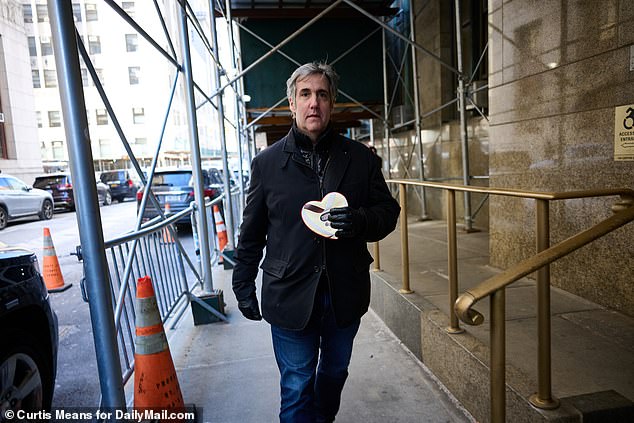 Trump's ex-lawyer was pictured by DailyMail.com walking down the street with the heart-shaped chocolate box