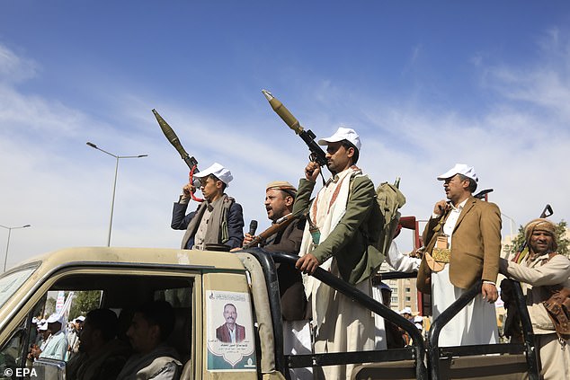 New Houthi recruits ride in a vehicle during a parade against the United States and Israel, in Sana'a, Yemen, on February 7