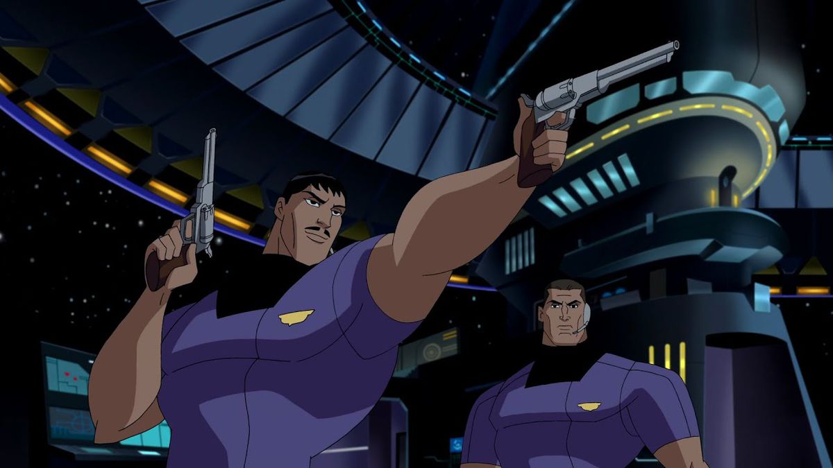 A man in a purple shirt pointing two revolvers next to another man in a purple shirt.