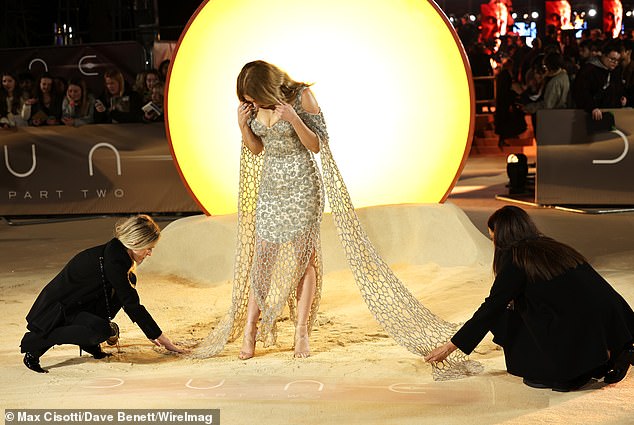 The James Bond actress completed the striking look with a diamond choker necklace and a pair of barely-there heels